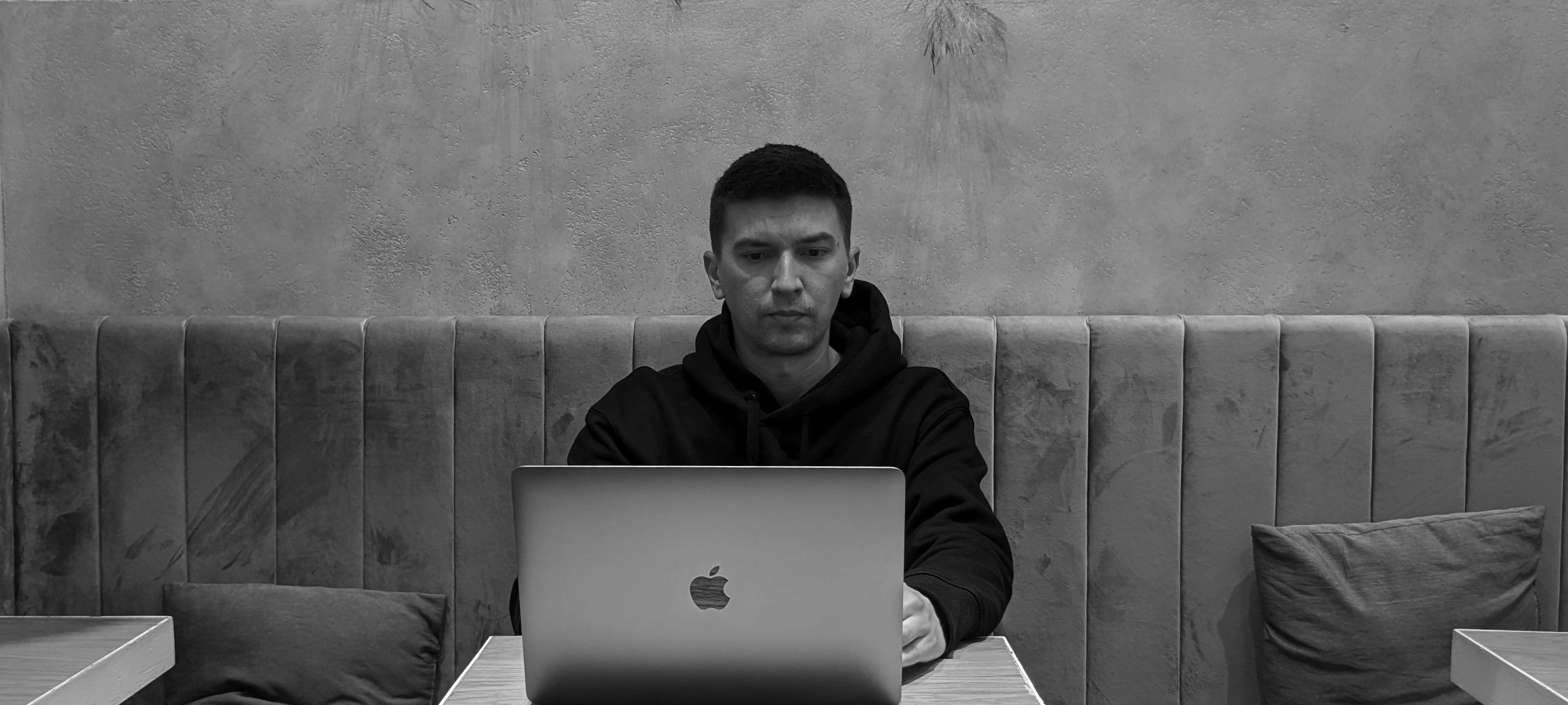Pavel sitting with a laptop at a cafe